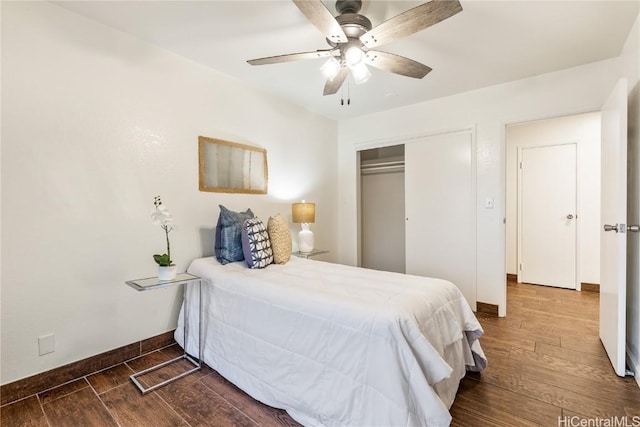 bedroom with ceiling fan, dark hardwood / wood-style flooring, and a closet