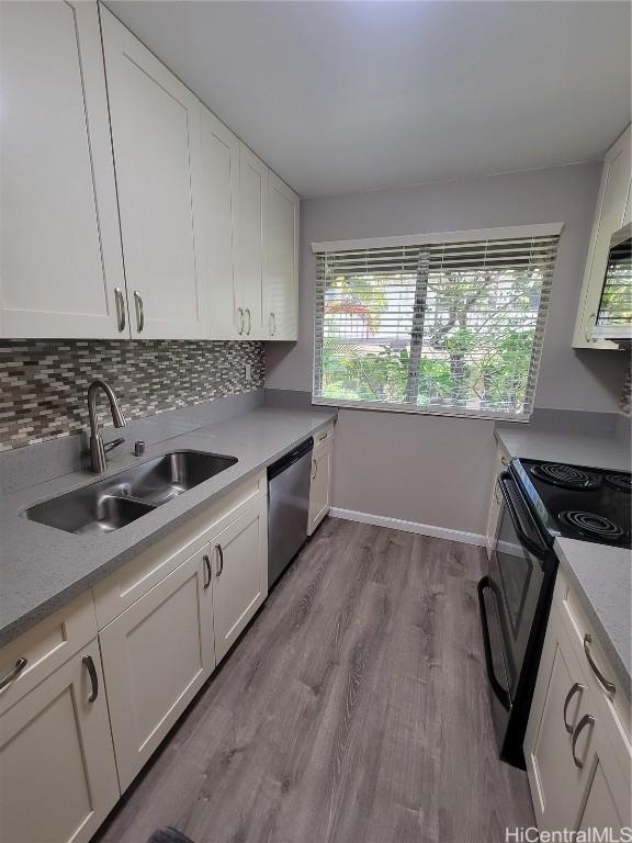 kitchen featuring white cabinetry, sink, decorative backsplash, stainless steel dishwasher, and black range with electric stovetop