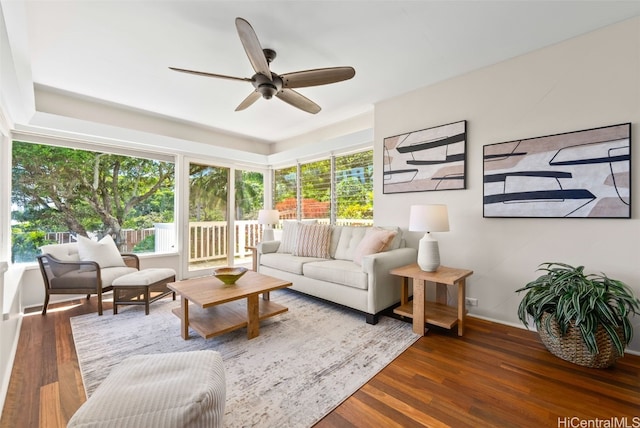 living room with dark wood-type flooring and ceiling fan