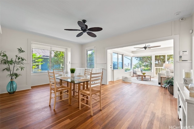 dining space featuring dark wood-type flooring and ceiling fan