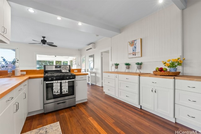 kitchen with white cabinetry, wooden counters, and stainless steel gas range