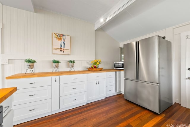 kitchen featuring crown molding, dark wood-type flooring, appliances with stainless steel finishes, butcher block counters, and white cabinets