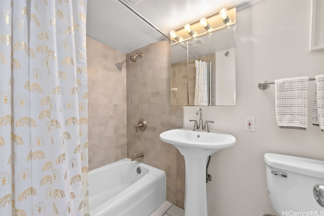 bathroom with shower / tub combo, tile patterned floors, and toilet