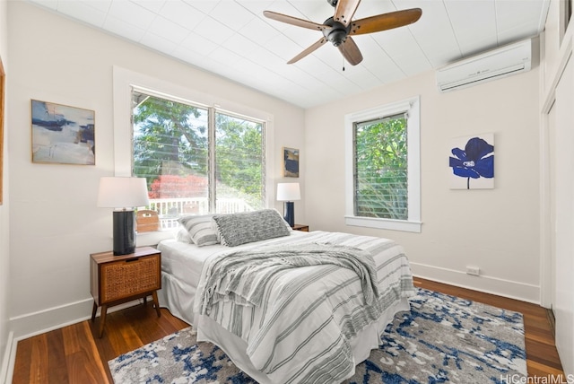 bedroom featuring ceiling fan, dark hardwood / wood-style flooring, and an AC wall unit