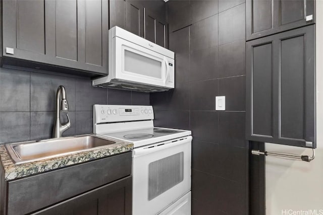 kitchen featuring tile walls, sink, white appliances, and decorative backsplash