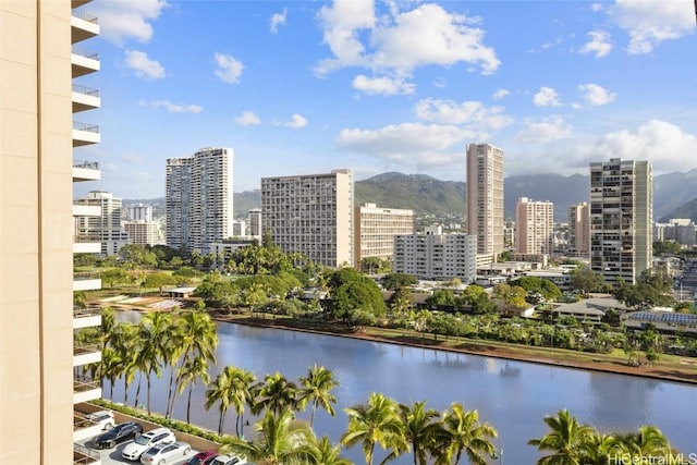 property's view of city with a water and mountain view