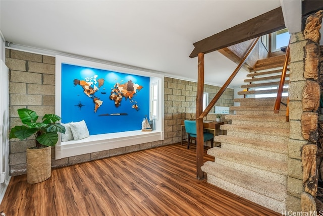 interior space featuring wood-type flooring and beam ceiling