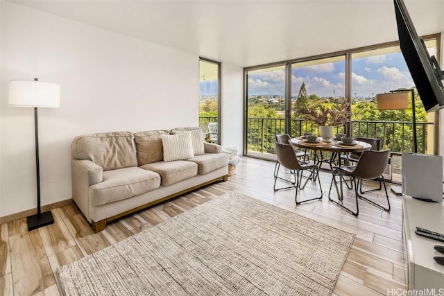 living room with expansive windows and light wood-type flooring