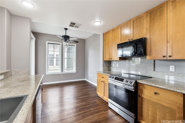 kitchen with appliances with stainless steel finishes, sink, ceiling fan, light stone countertops, and dark wood-type flooring