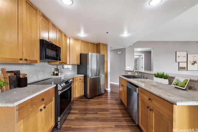 kitchen with sink, dark hardwood / wood-style flooring, decorative backsplash, light stone counters, and stainless steel appliances