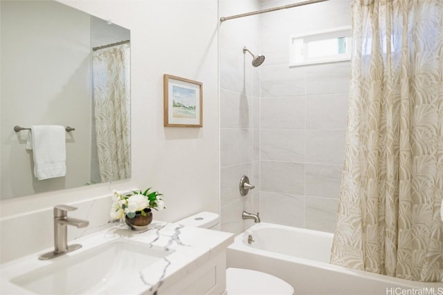 full bathroom with vanity, shower / bath combo, and toilet