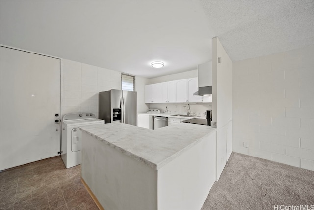 kitchen featuring washer / clothes dryer, white cabinetry, appliances with stainless steel finishes, and kitchen peninsula