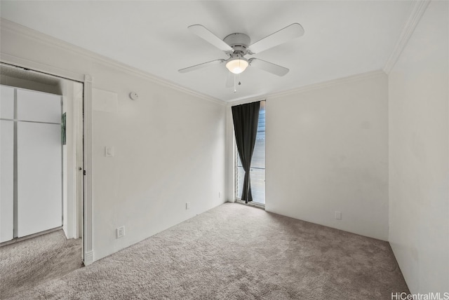 unfurnished bedroom featuring crown molding, carpet, and ceiling fan