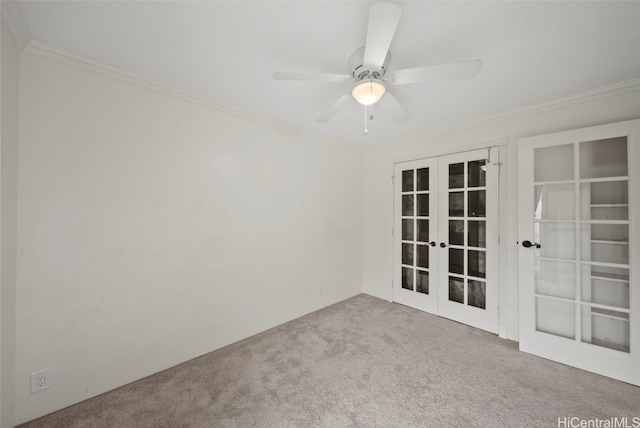 carpeted empty room featuring ornamental molding, french doors, and ceiling fan