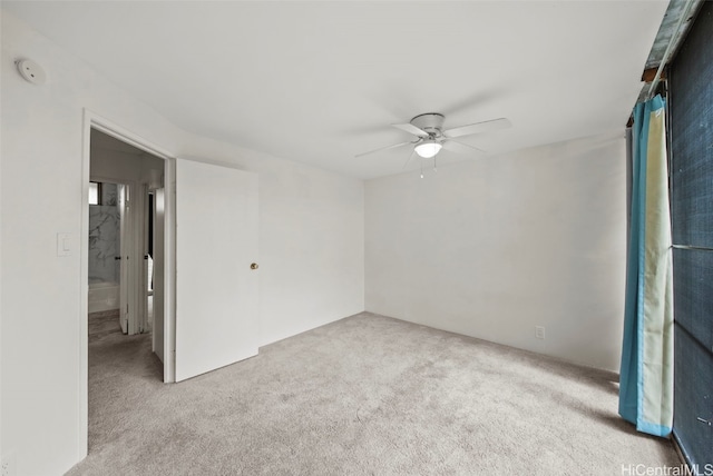 spare room with light carpet and ceiling fan