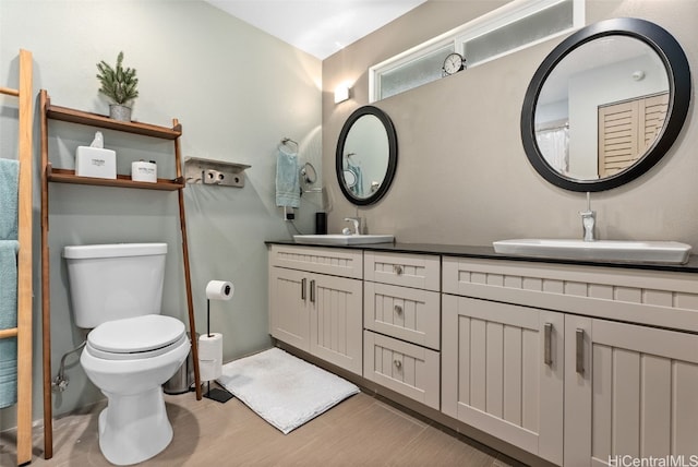 bathroom with vanity, hardwood / wood-style flooring, and toilet