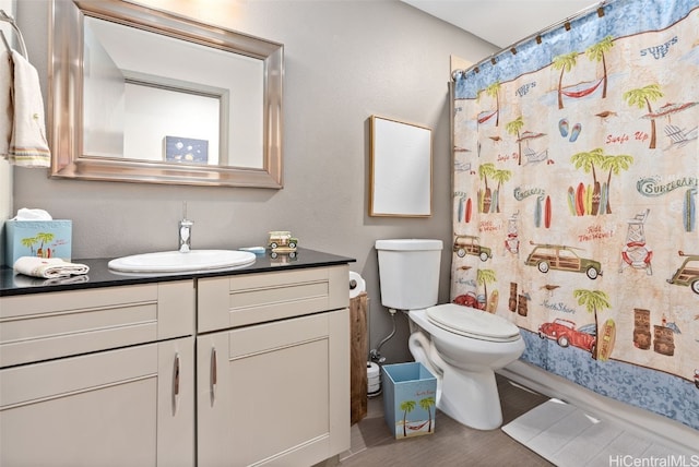 bathroom with a shower with curtain, vanity, toilet, and hardwood / wood-style floors