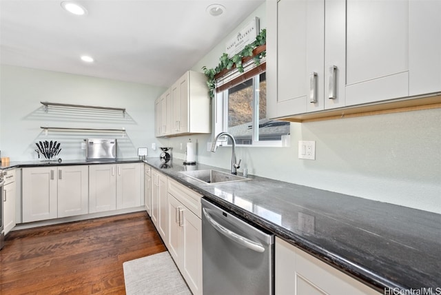 kitchen with white cabinetry, dishwasher, sink, dark stone countertops, and dark hardwood / wood-style flooring