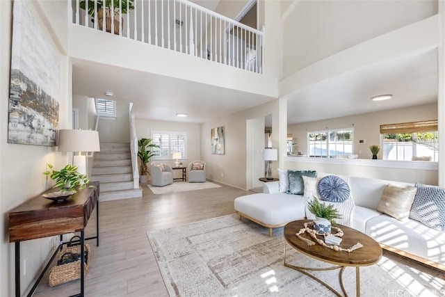 living room featuring light hardwood / wood-style floors and a high ceiling