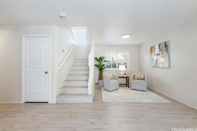 stairway featuring hardwood / wood-style flooring and plenty of natural light