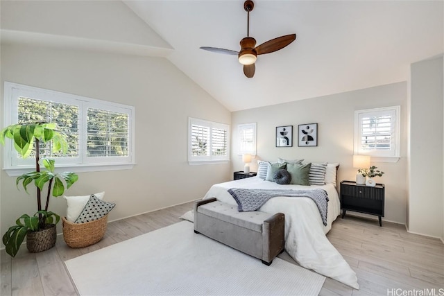 bedroom featuring ceiling fan, lofted ceiling, and light wood-type flooring