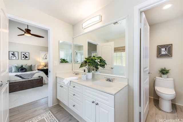 bathroom featuring vanity, ceiling fan, and toilet