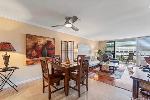 dining space with expansive windows, ceiling fan, ornamental molding, and light tile patterned floors