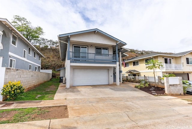 view of front of property featuring a garage and a balcony