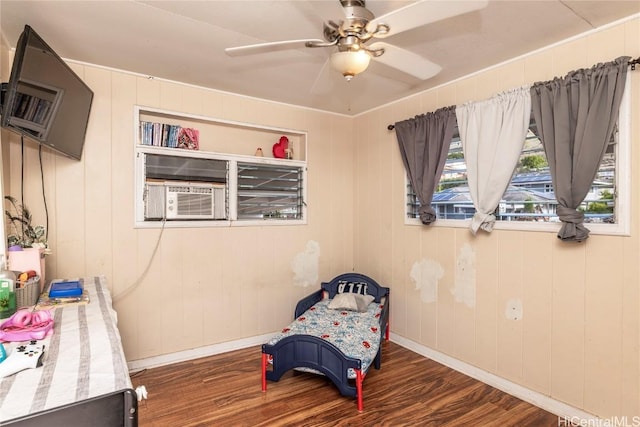 living area with cooling unit, ceiling fan, and dark hardwood / wood-style flooring