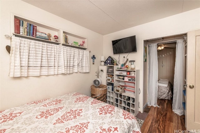 bedroom featuring dark wood-type flooring and a textured ceiling