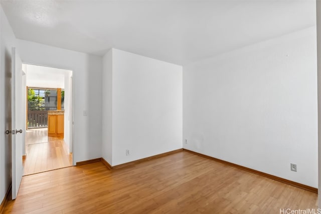 spare room featuring light wood-type flooring