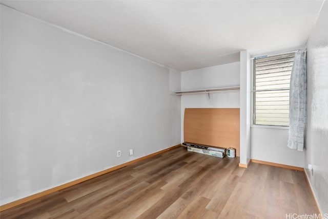 interior space with wood finished floors and baseboards