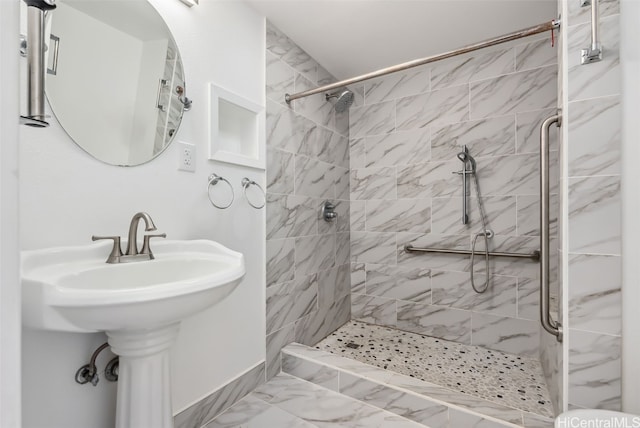 full bath with a stall shower and marble finish floor