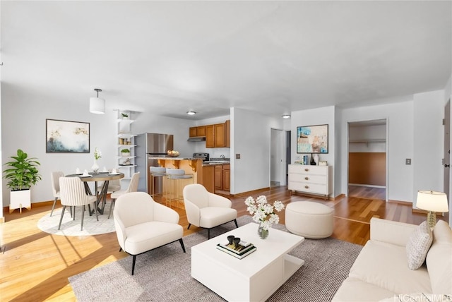 living room with light wood-style floors and baseboards