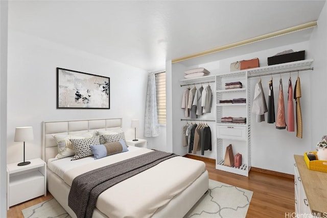 bedroom featuring light wood-type flooring and a closet