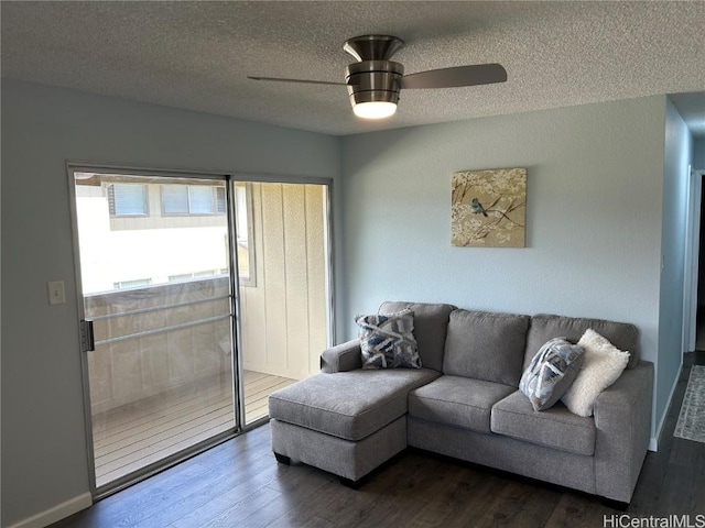 living room with ceiling fan, wood-type flooring, and a textured ceiling