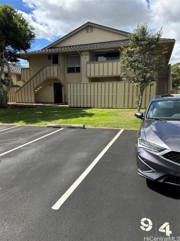 view of car parking with a lawn