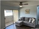living area with a ceiling fan