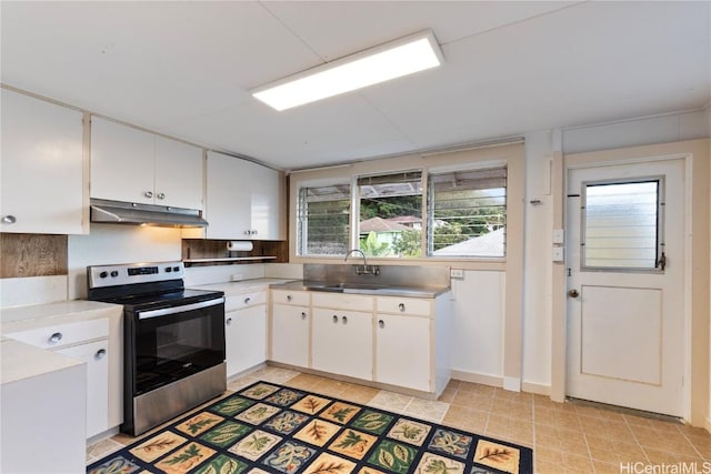 kitchen featuring white cabinetry, sink, electric range, and light tile patterned flooring