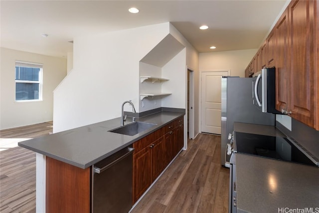 kitchen with sink, stainless steel appliances, and dark hardwood / wood-style floors