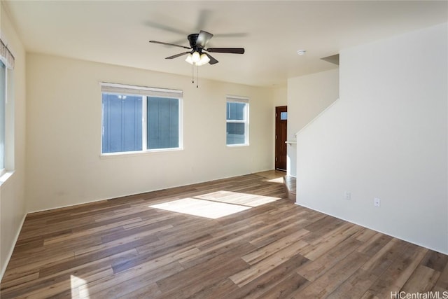 empty room featuring hardwood / wood-style flooring and ceiling fan