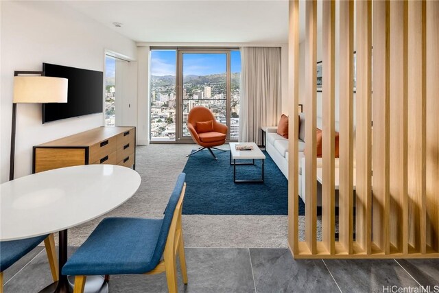 carpeted living room featuring a wall of windows