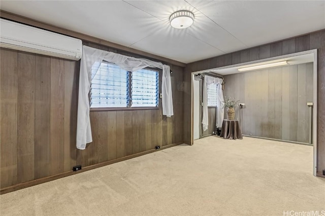 unfurnished bedroom with an AC wall unit, light colored carpet, and wooden walls