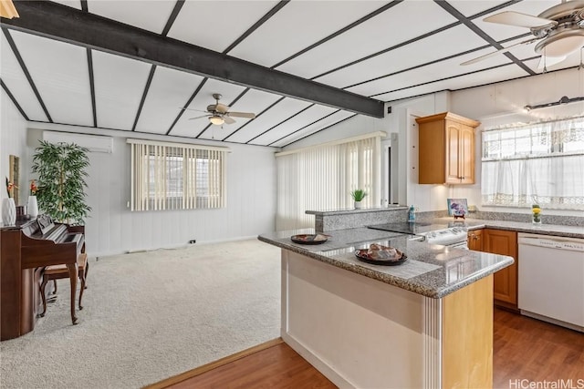 kitchen with ceiling fan, white dishwasher, lofted ceiling with beams, light stone countertops, and kitchen peninsula