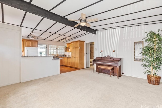 misc room with ceiling fan, light carpet, and vaulted ceiling with beams