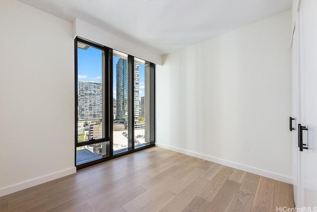 empty room with light hardwood / wood-style flooring