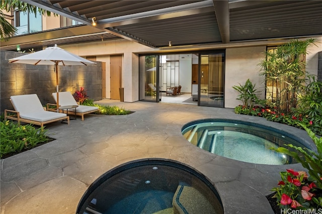 view of swimming pool with a patio area and an in ground hot tub