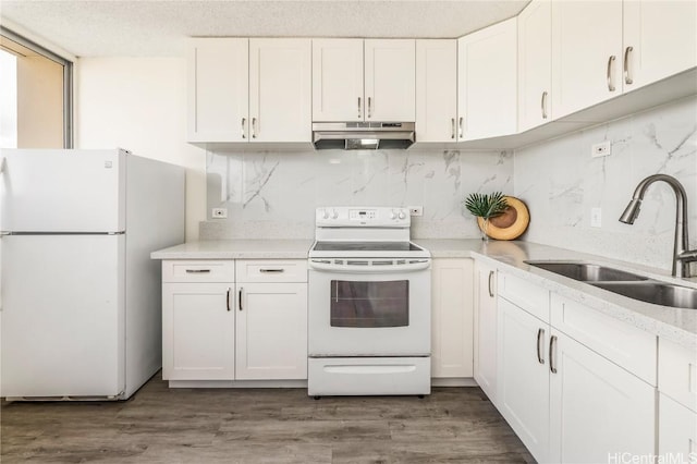 kitchen featuring white cabinetry, sink, backsplash, hardwood / wood-style flooring, and white appliances