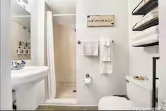 bathroom with toilet and a shower