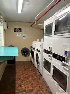 clothes washing area featuring stacked washer and dryer and washer and dryer